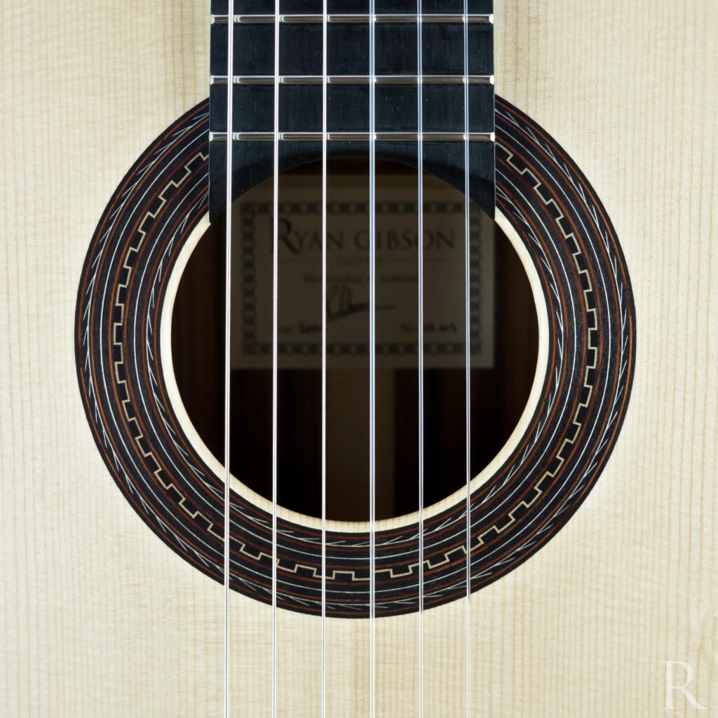 Rosette with chain detail on spruce soundboard of handmade classical guitar