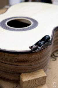 Planing purfling detail on spruce top classical guitar