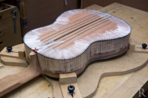 Ebony back binding being glued on handmade classical guitar
