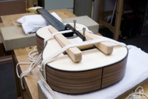 Gluing on Indian rosewood bridge for handmade classical guitar