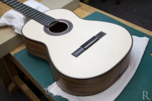 Finely sanded spruce top of Santos rosewood classical guitar
