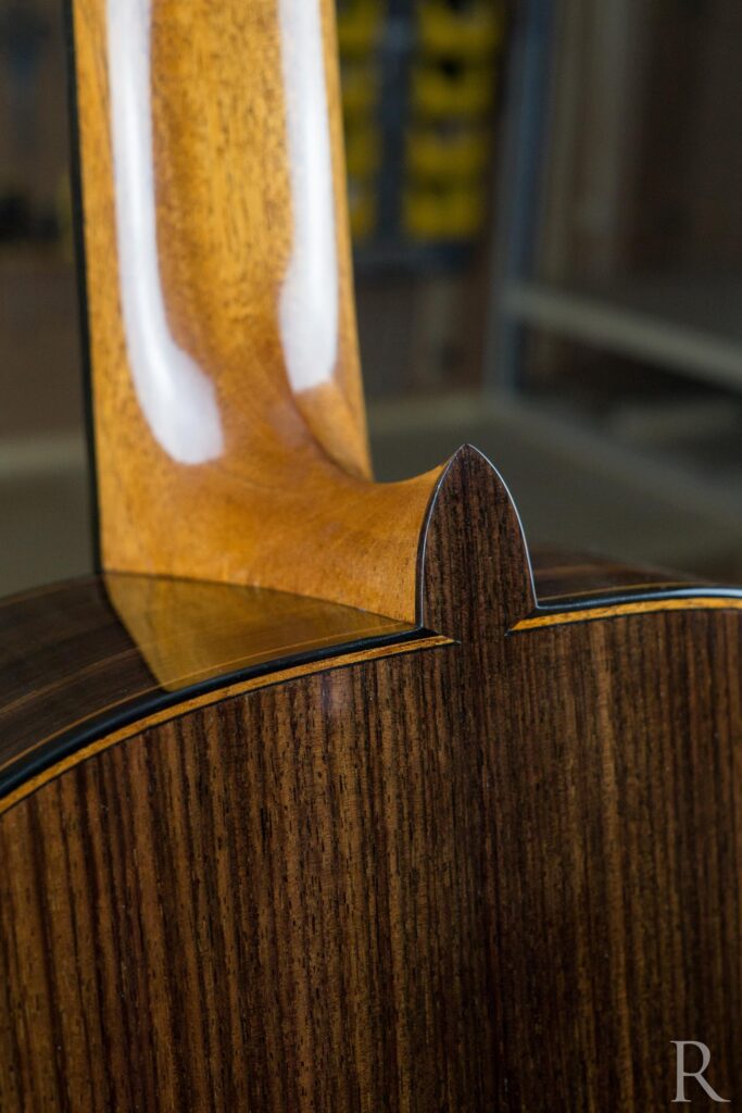 Heel cap detail of handmade classical guitar in ebony and Indian rosewood