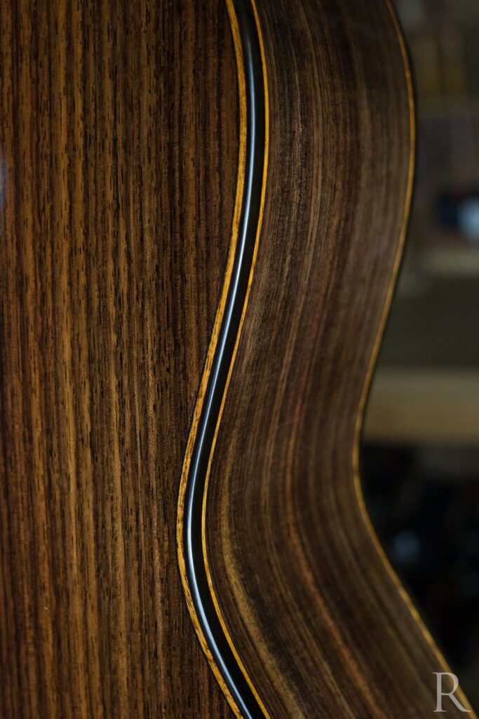 Back detail with mahogany from a handmade classical guitar in ebony and Indian rosewood