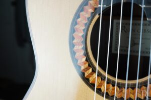Solid wood rosette detail of cedar top handmade classical guitar